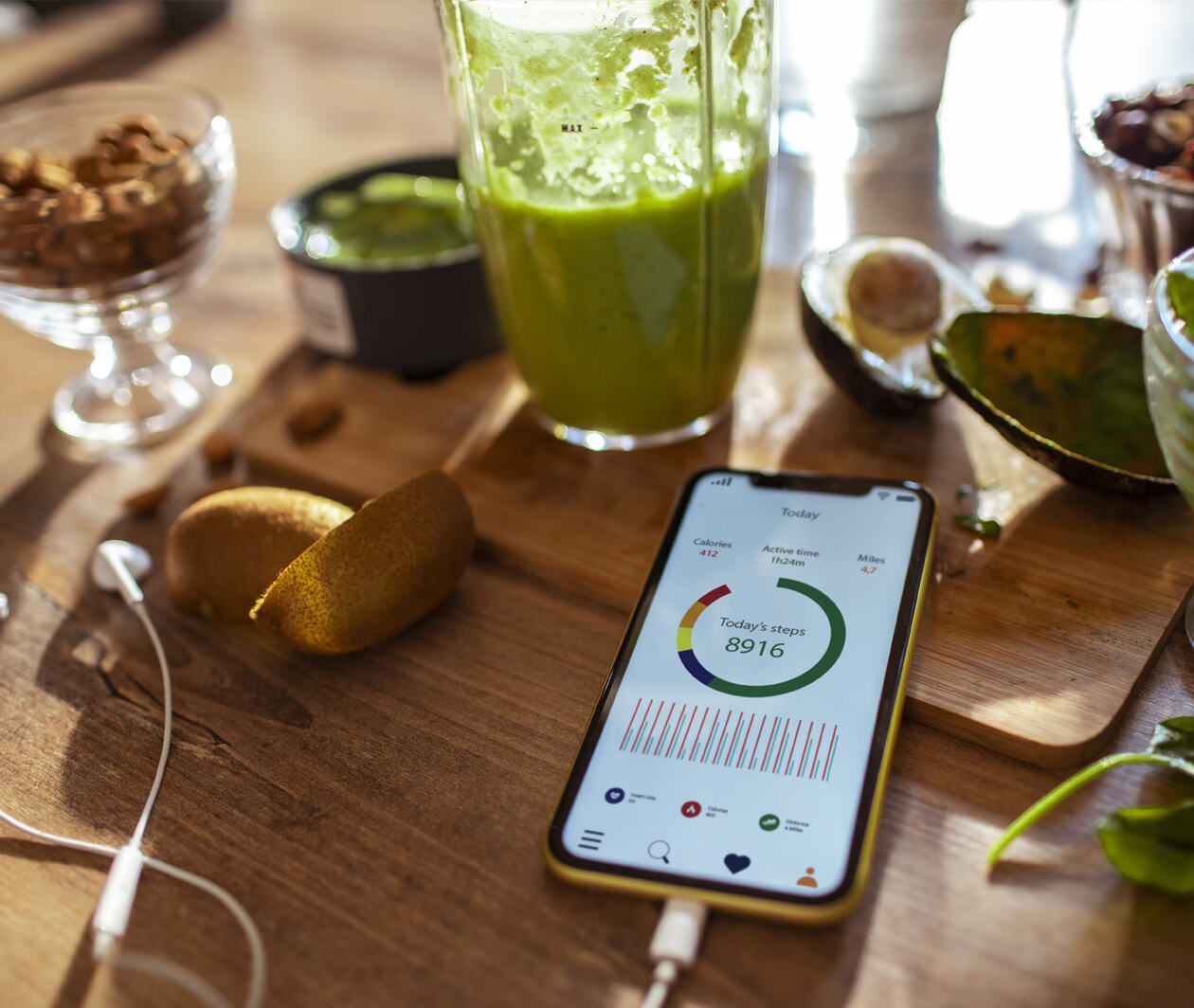 A mobile phone on a table surrounded by healthy foods