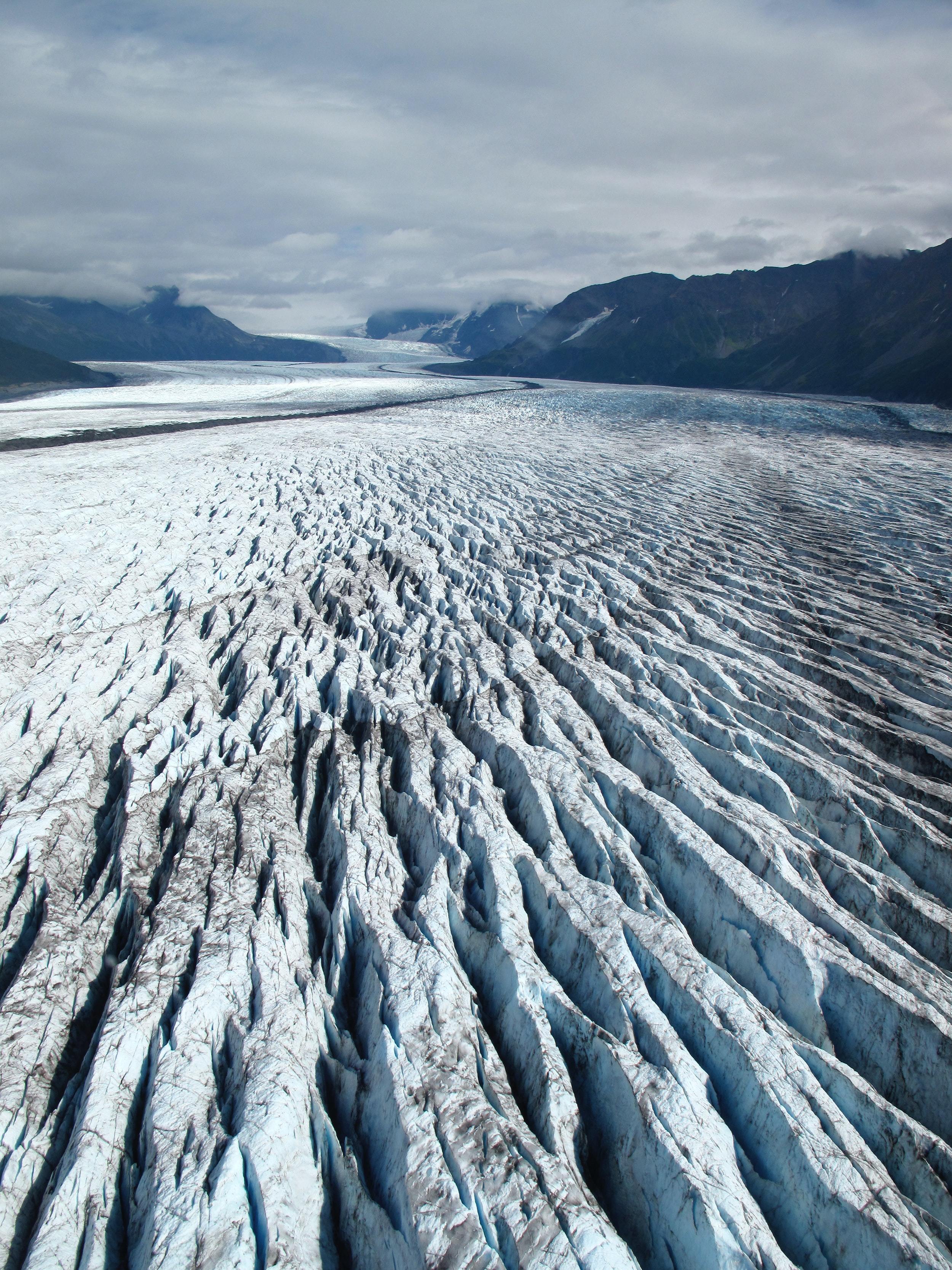 View looking along the surface of a heavily crevassed glacier