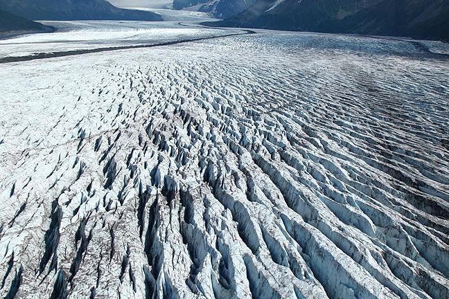 View looking along the surface of a heavily crevassed glacier