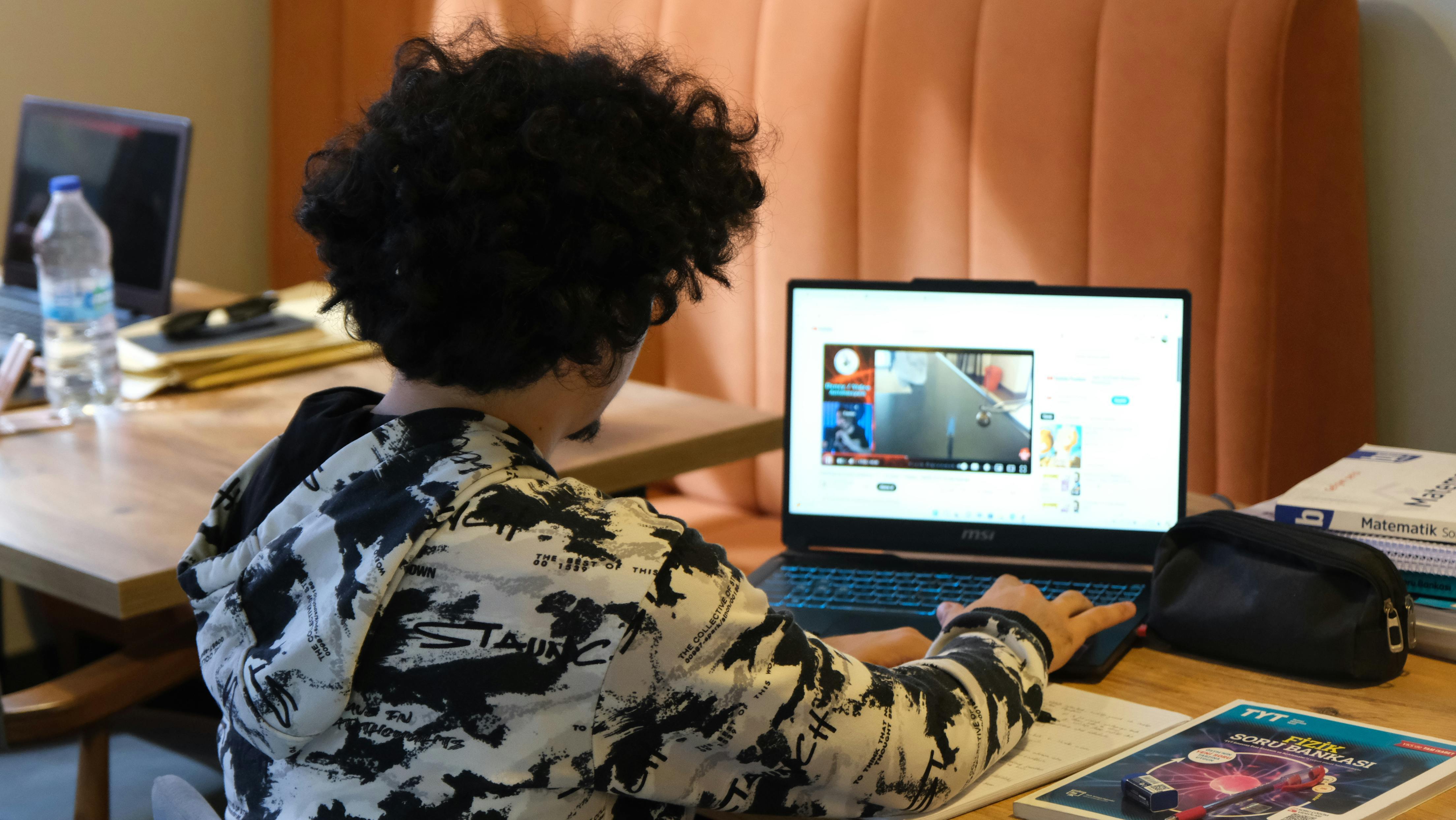Digital capability - using digital tools to support collaboration, feedback and active learning. Student using a laptop