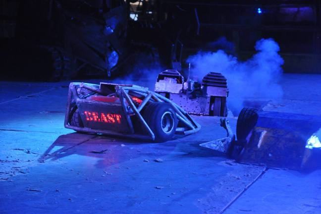 Several 100kg robots fighting in a robot wars arena