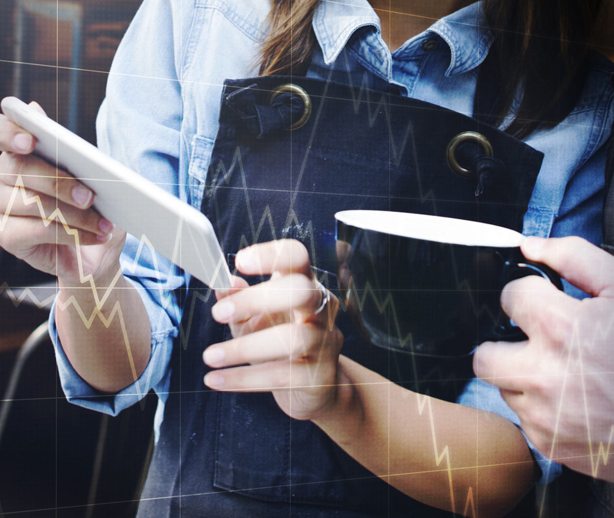 A woman and a man in business attire are looking at graphs 