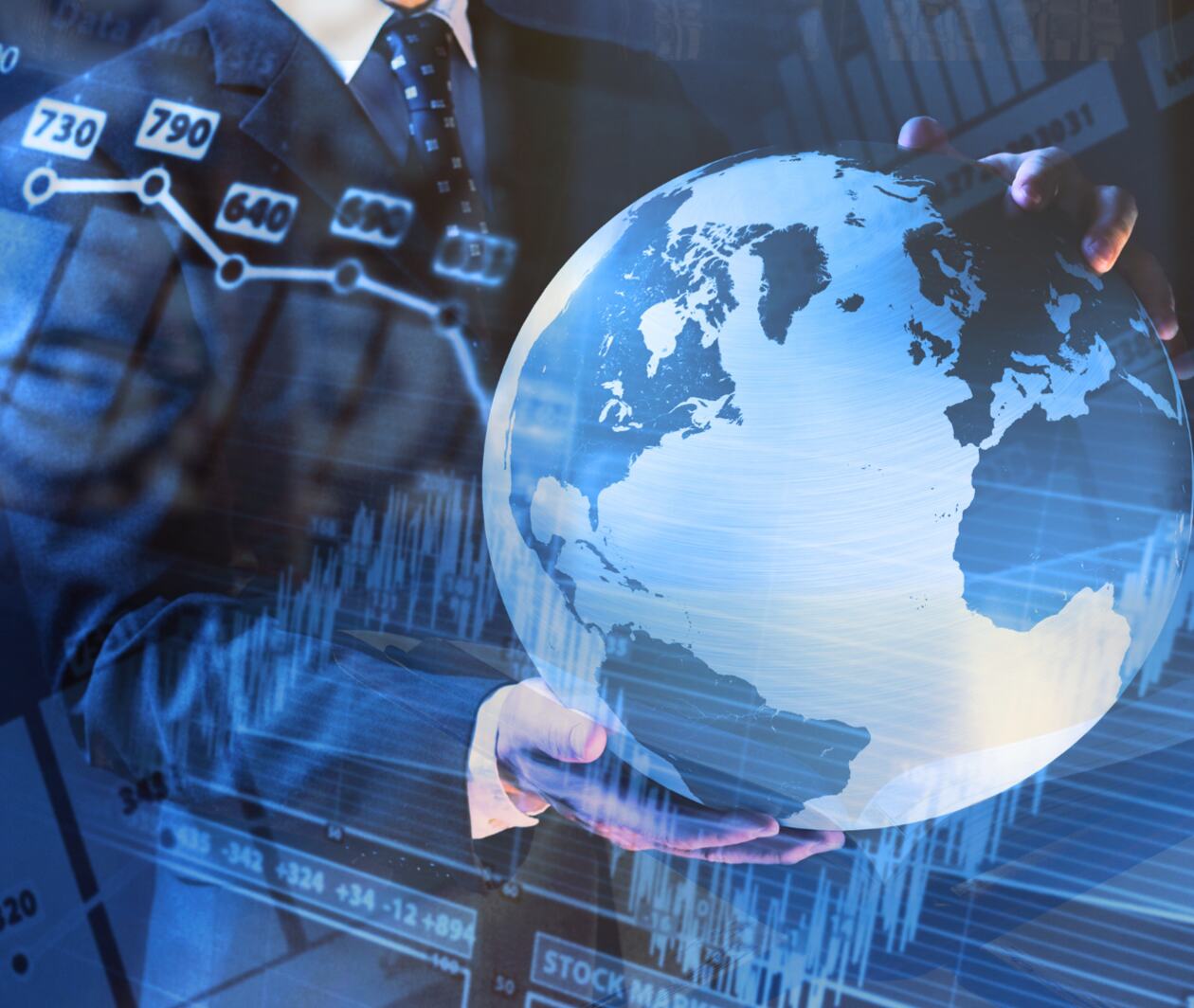 businessman holding world globe in front of stock market chart with an open quran on a wooden stand in front of an arabic door