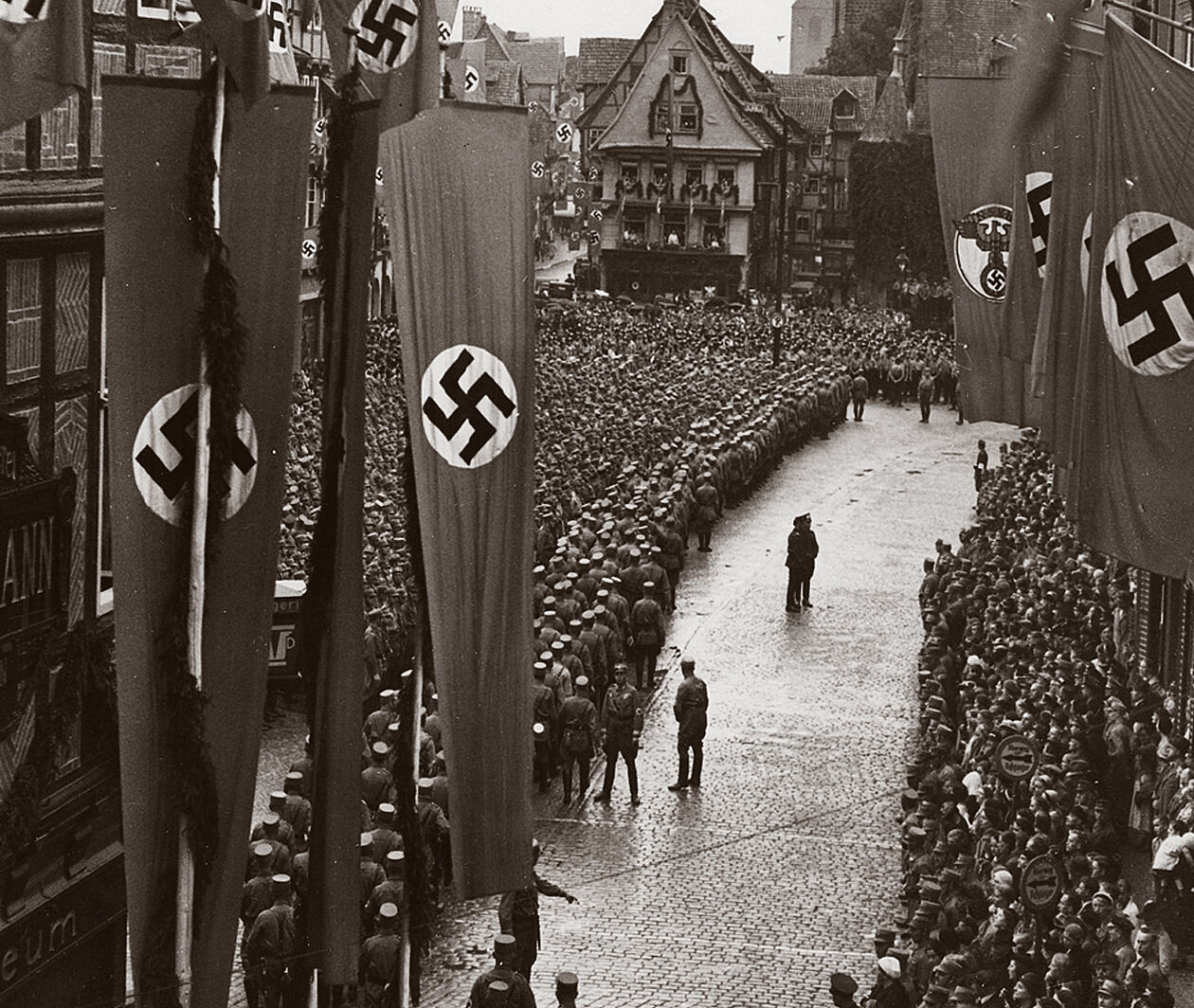 Nazi banners and flags flying over a crowded street