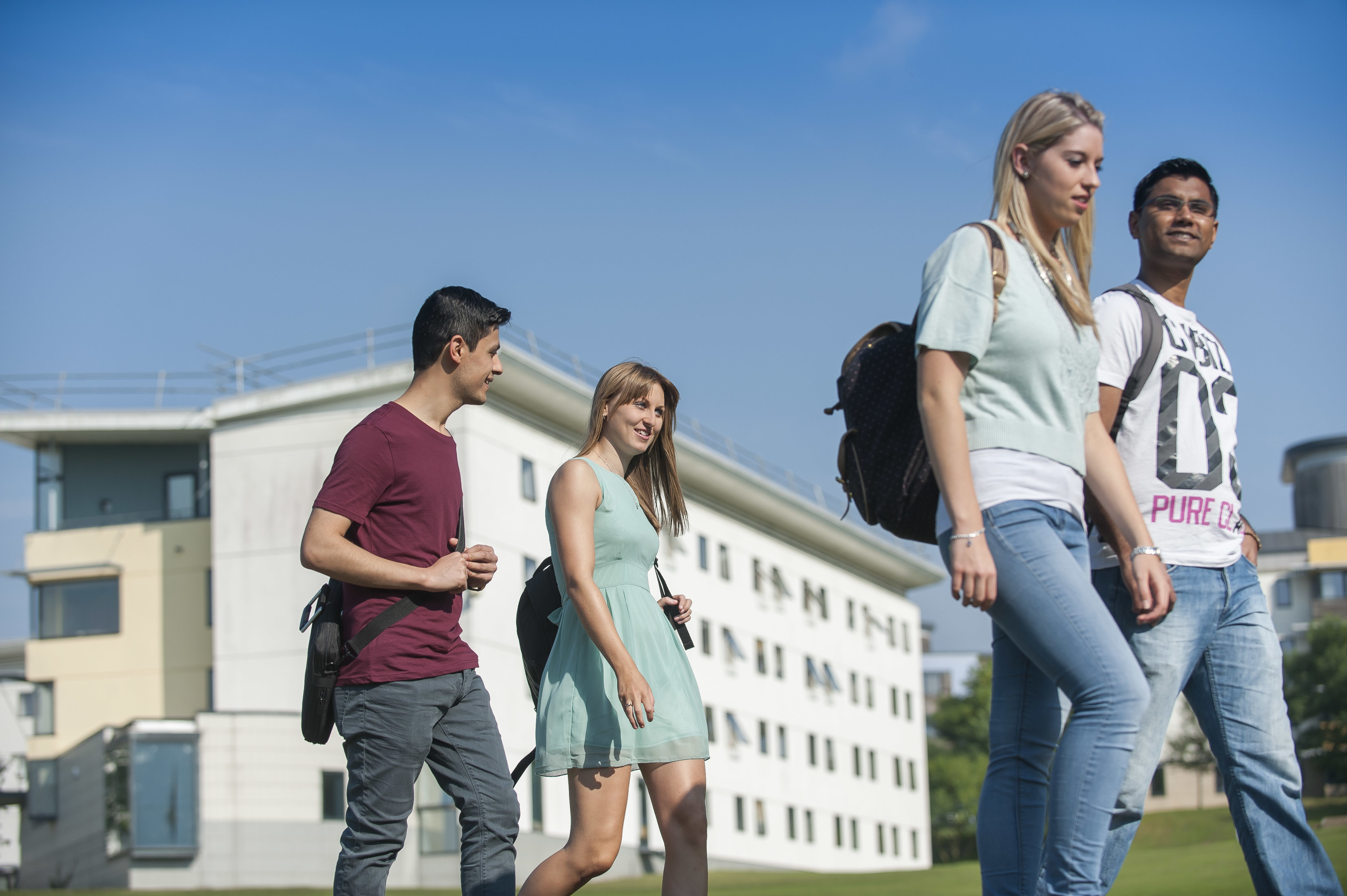 Students walking across UEA campus