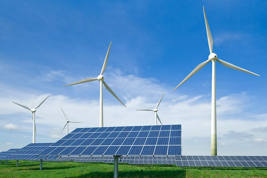 Solar panels and wind turbines in a field