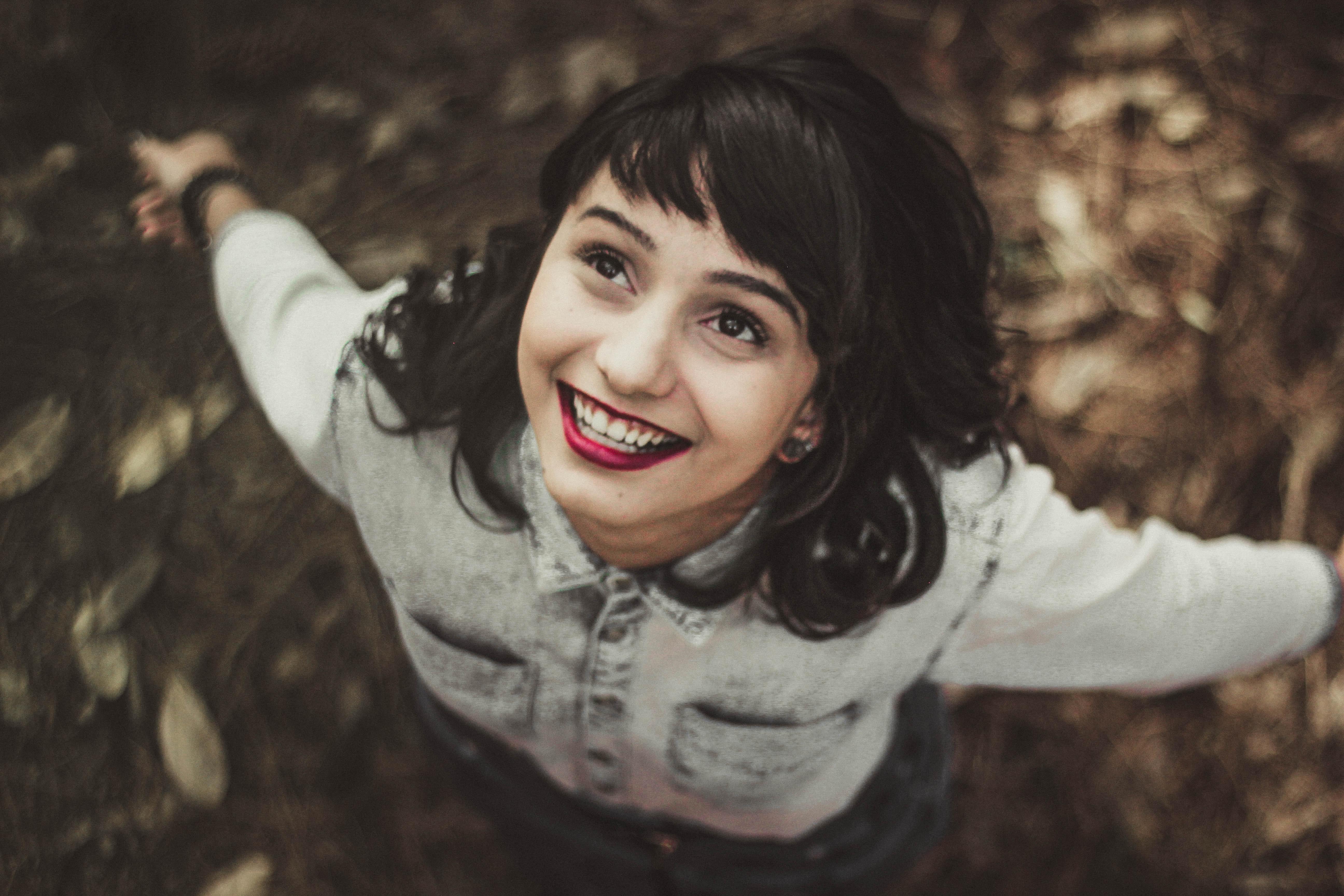 A young woman looking to the sky and smiling