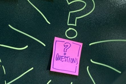 A post-it note with a question mark written on it and the word 'questions' 