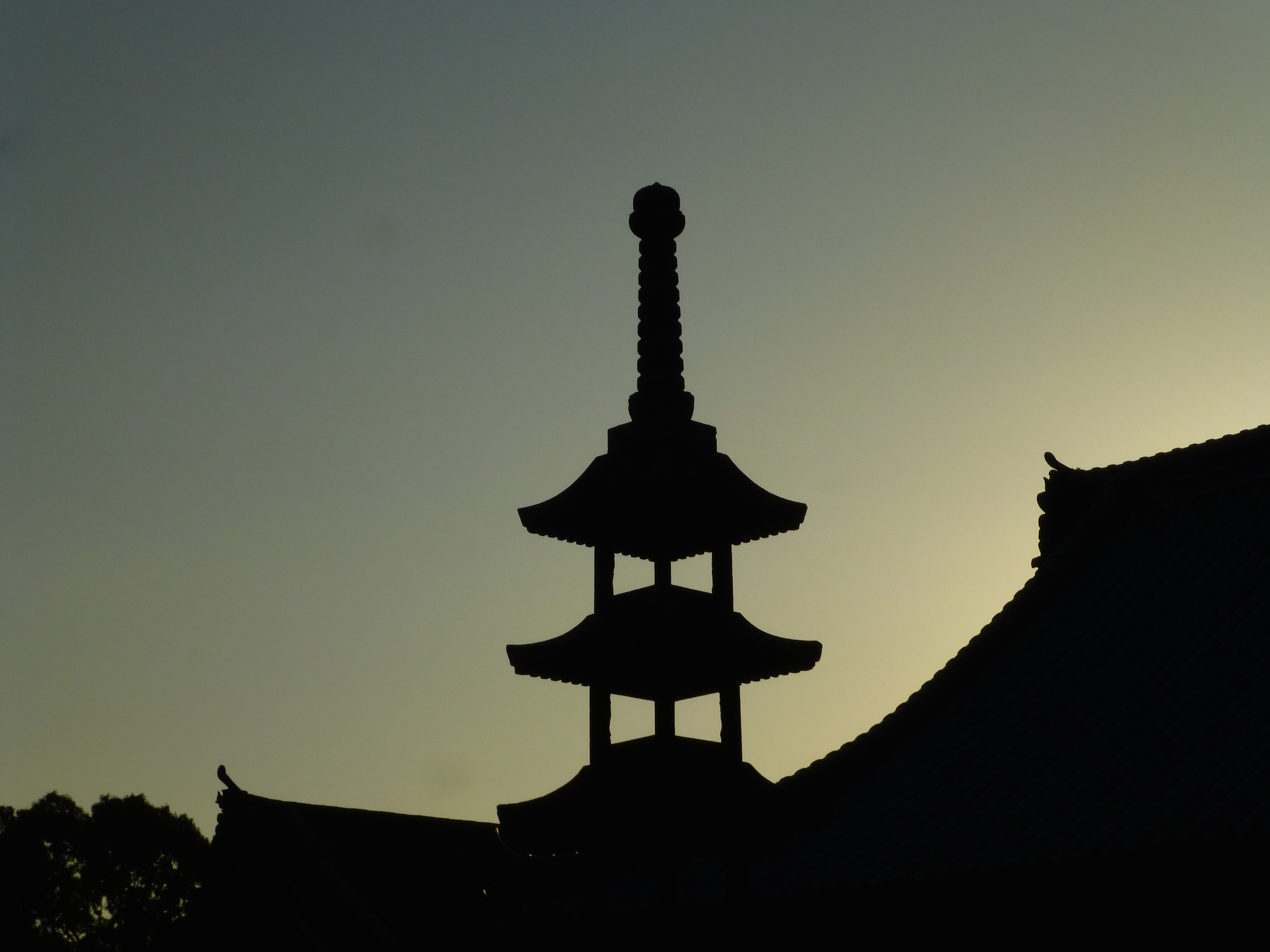 Temple silhouet against sunset sky