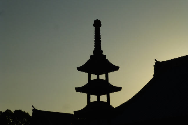 Temple silhouet against sunset sky