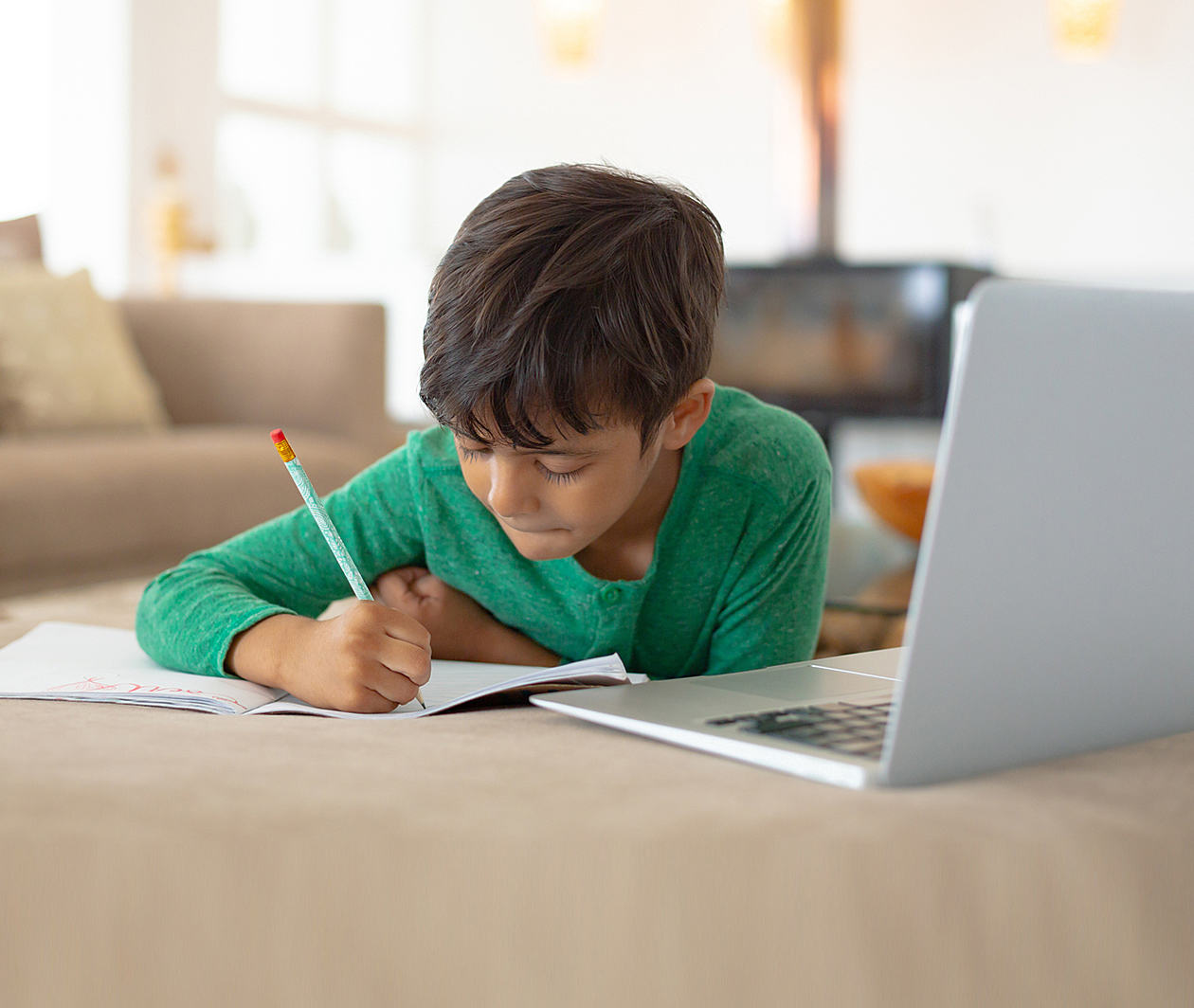 A young learner, studying in front of a laptop