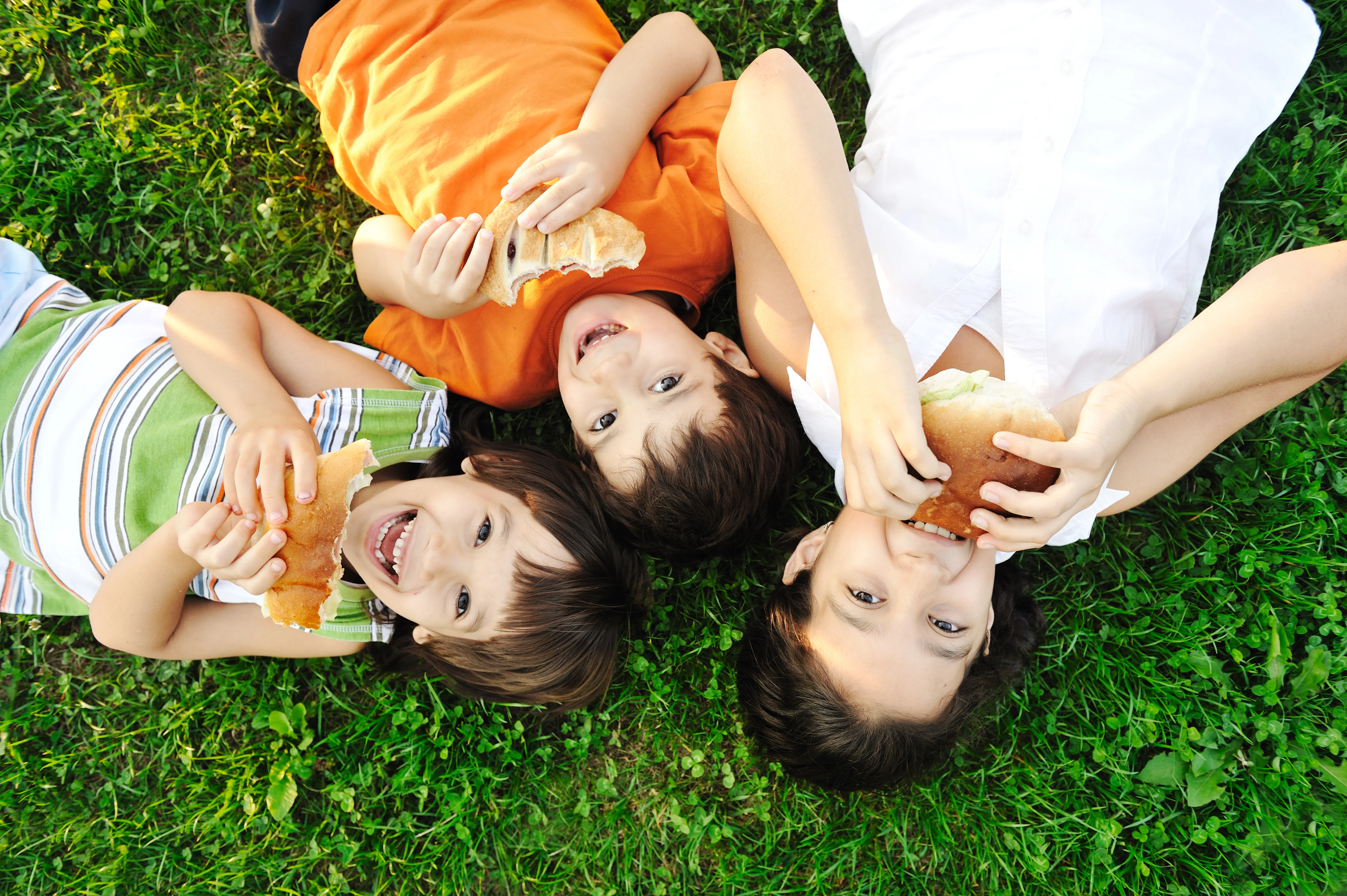 photograph of children eating bread