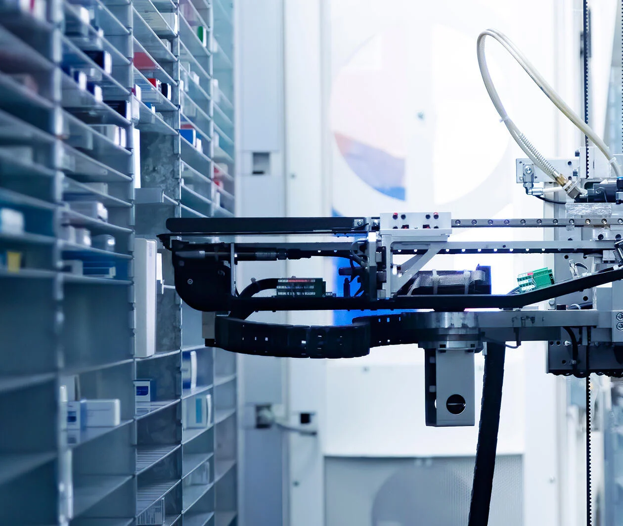 Modern pharmacy storage room and two robot hand s are arranging and storing out drugs in a pharmacy