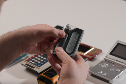 Educator holding and examining a twist grip feature of an electronics device.