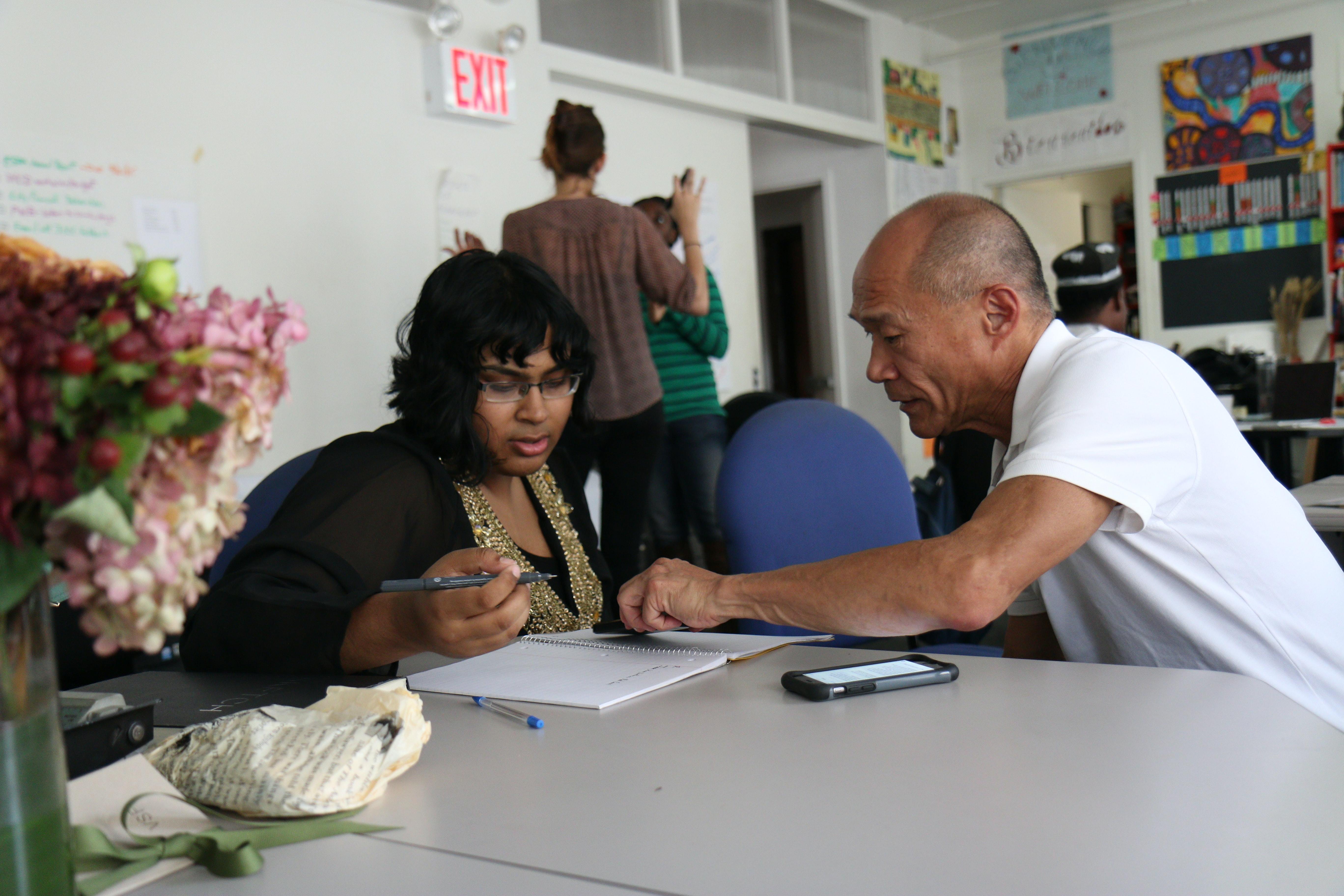 Man and women having a discussion and making notes