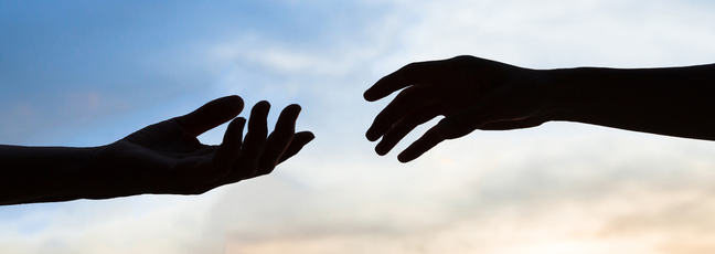 two hands reaching out to touch each other