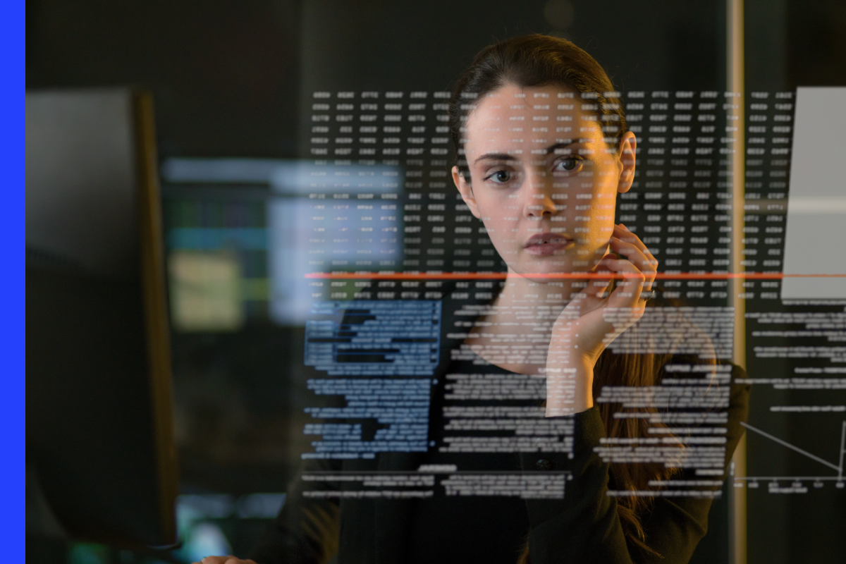 A woman looks at a set of data tables.