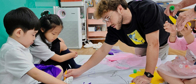 An adult teacher with two younger pupils