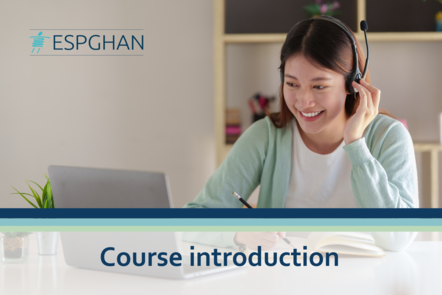 Person with headset smiling, sitting in front of laptop