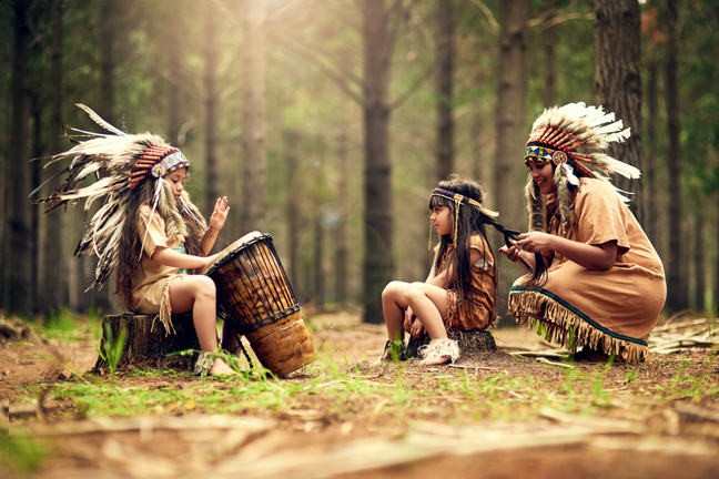 American Indian mother and two daughters with drum