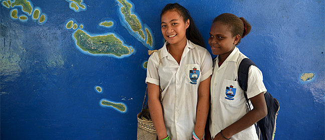 Two girls standing in front of a map