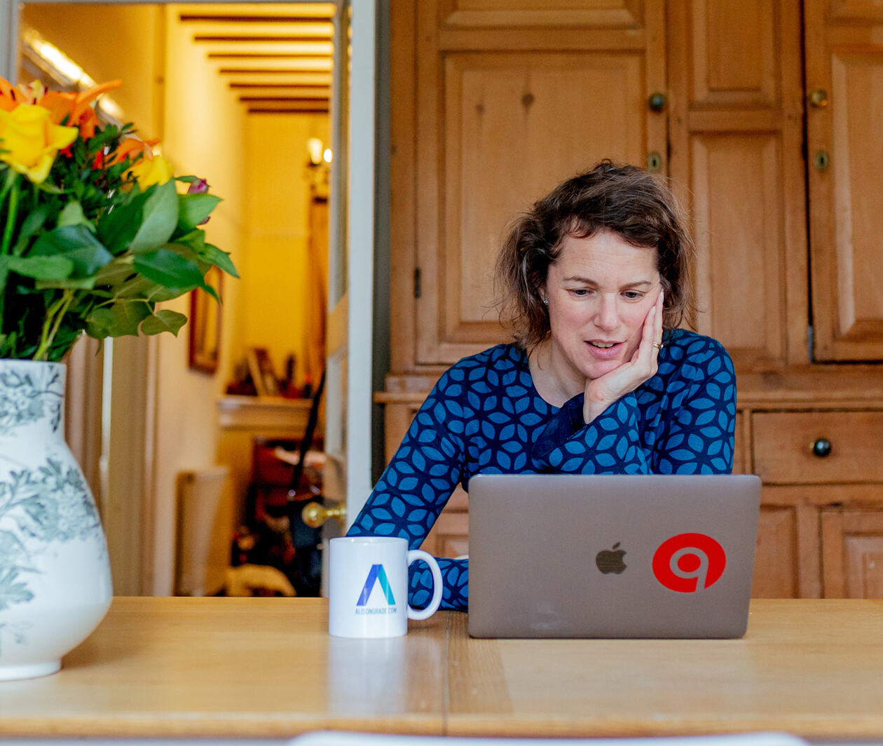 The Freelance Bible's author Alison Grade working from home with her laptop computer.