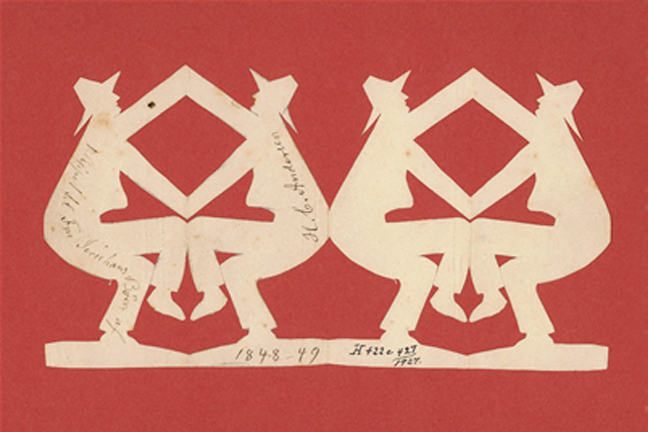 A Hans Christian Andersen paper cut showing four men touching hands and knees two and two