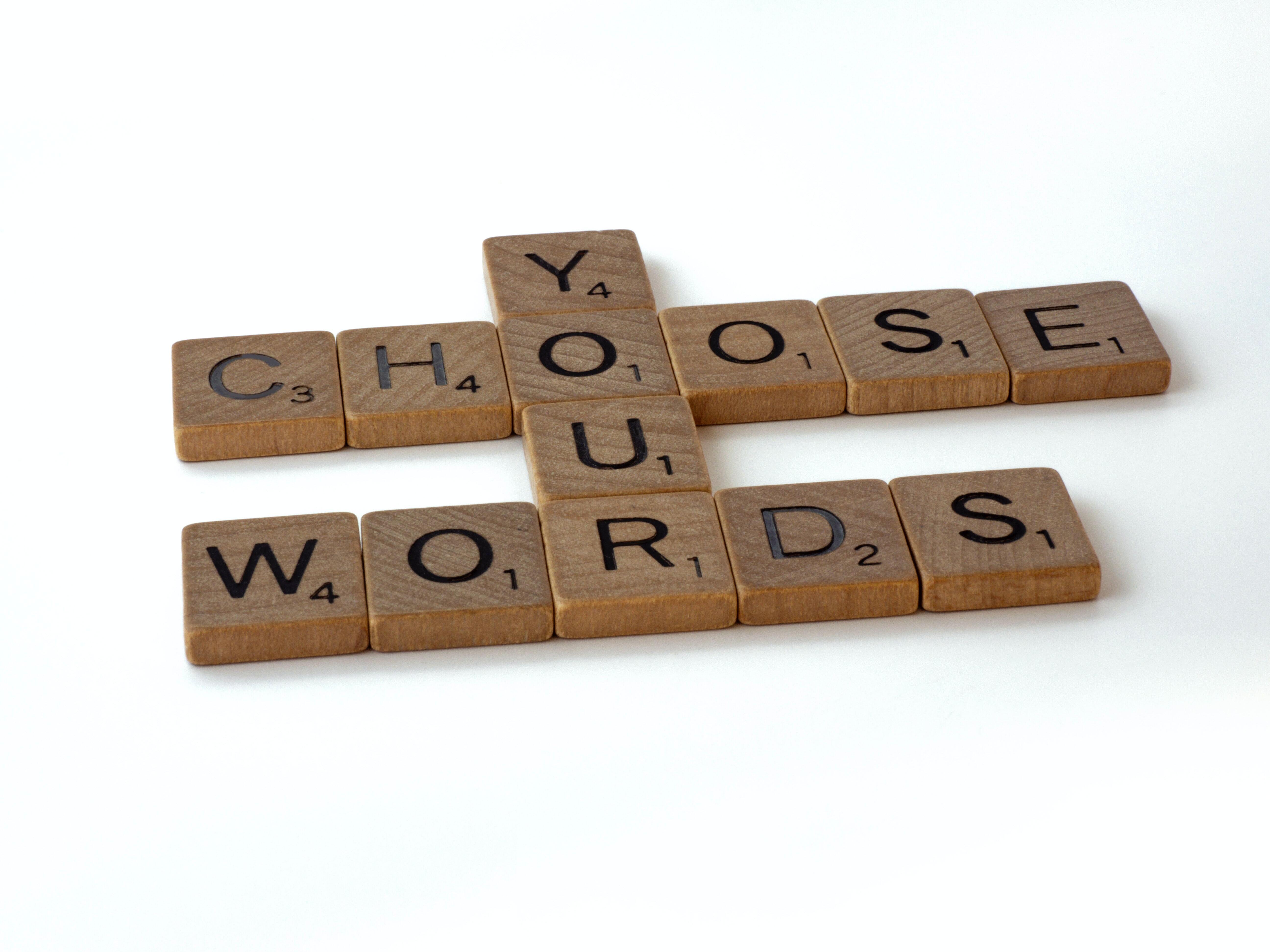 Scrabble tiles spelling out 'choose your words'