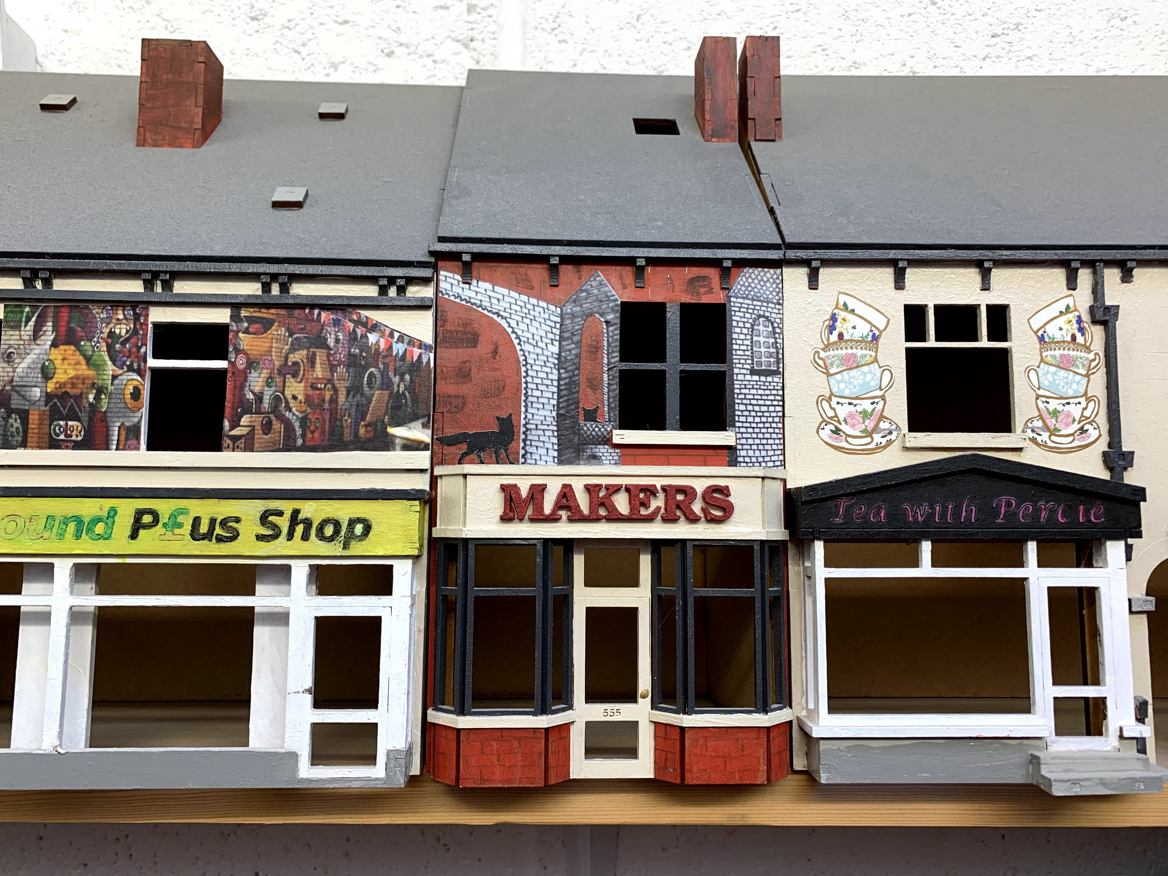 A model of a row of shops, including a makerspace