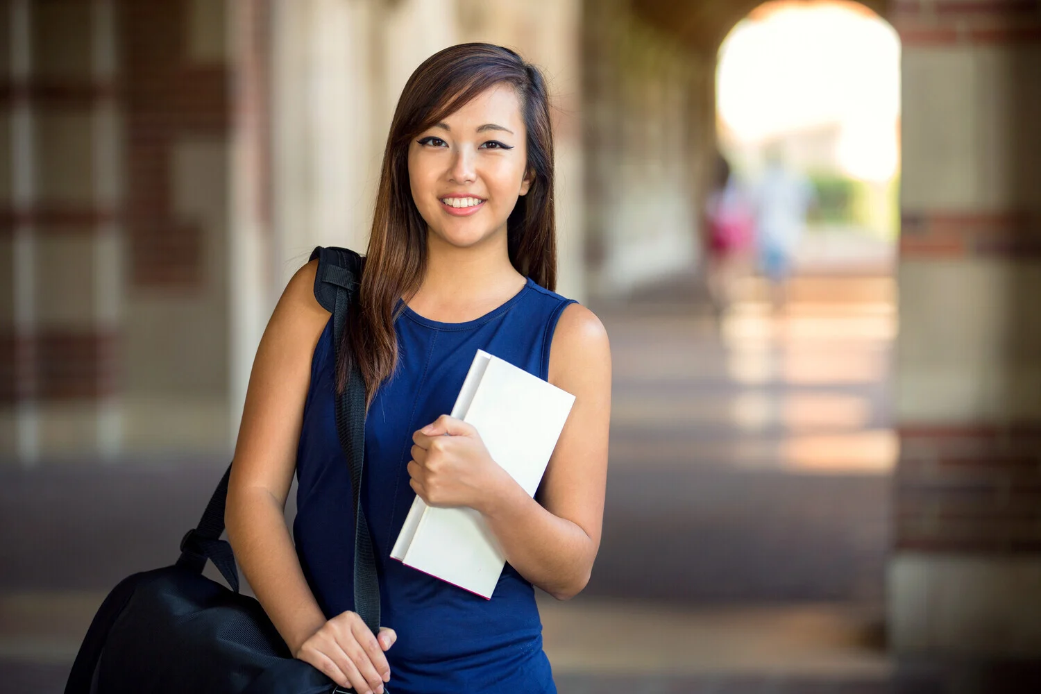 Image of a interview candidate holding a book and a bag