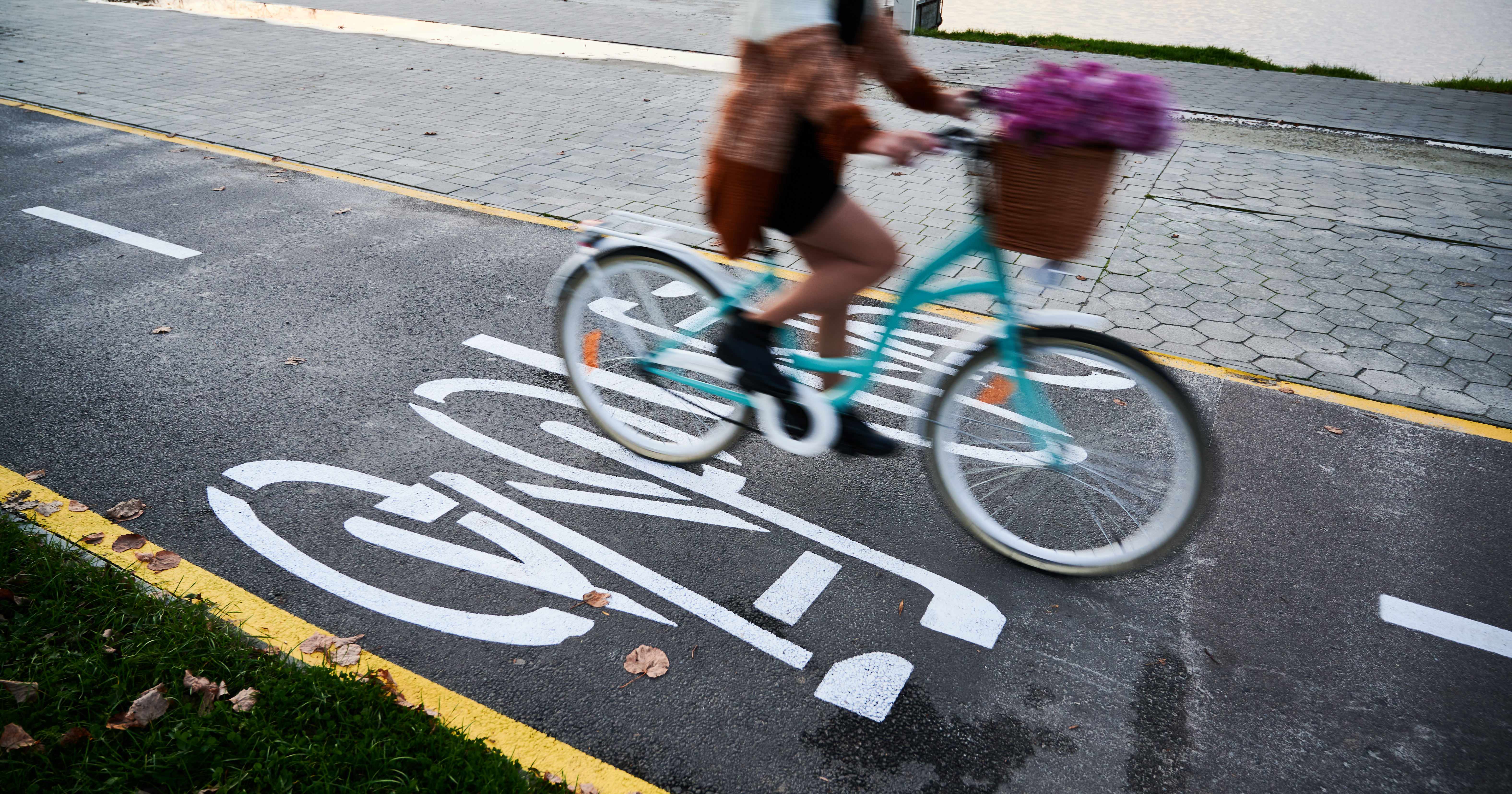 Woman riding bicycle on bike lane in centre city.