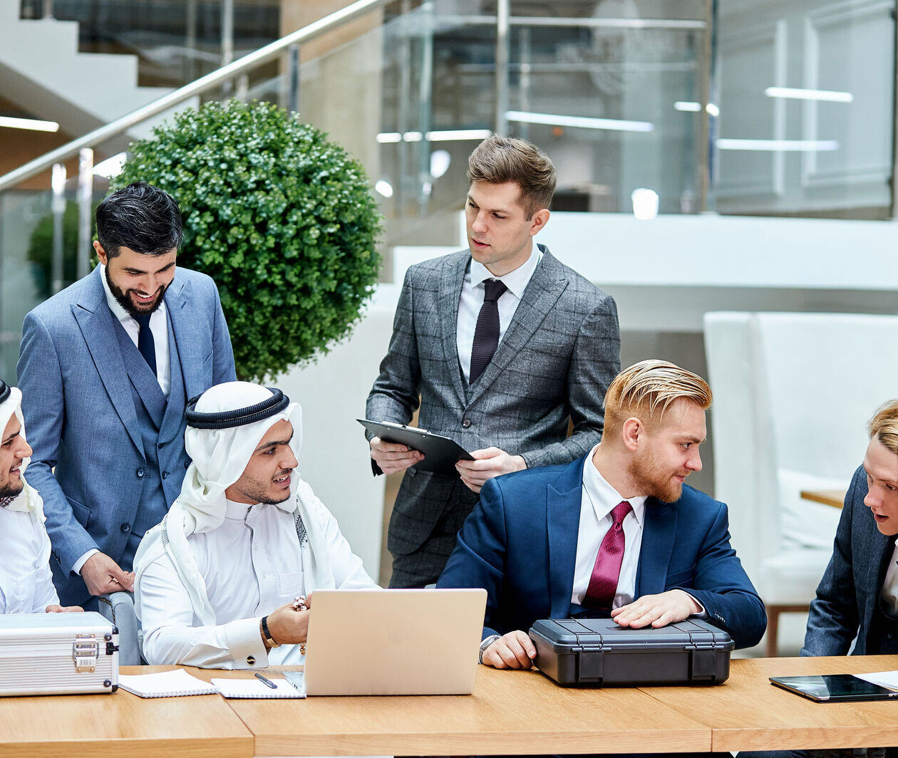 a group of businesspeople gathering in a discussion