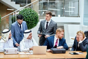 a group of businesspeople gathering in a discussion