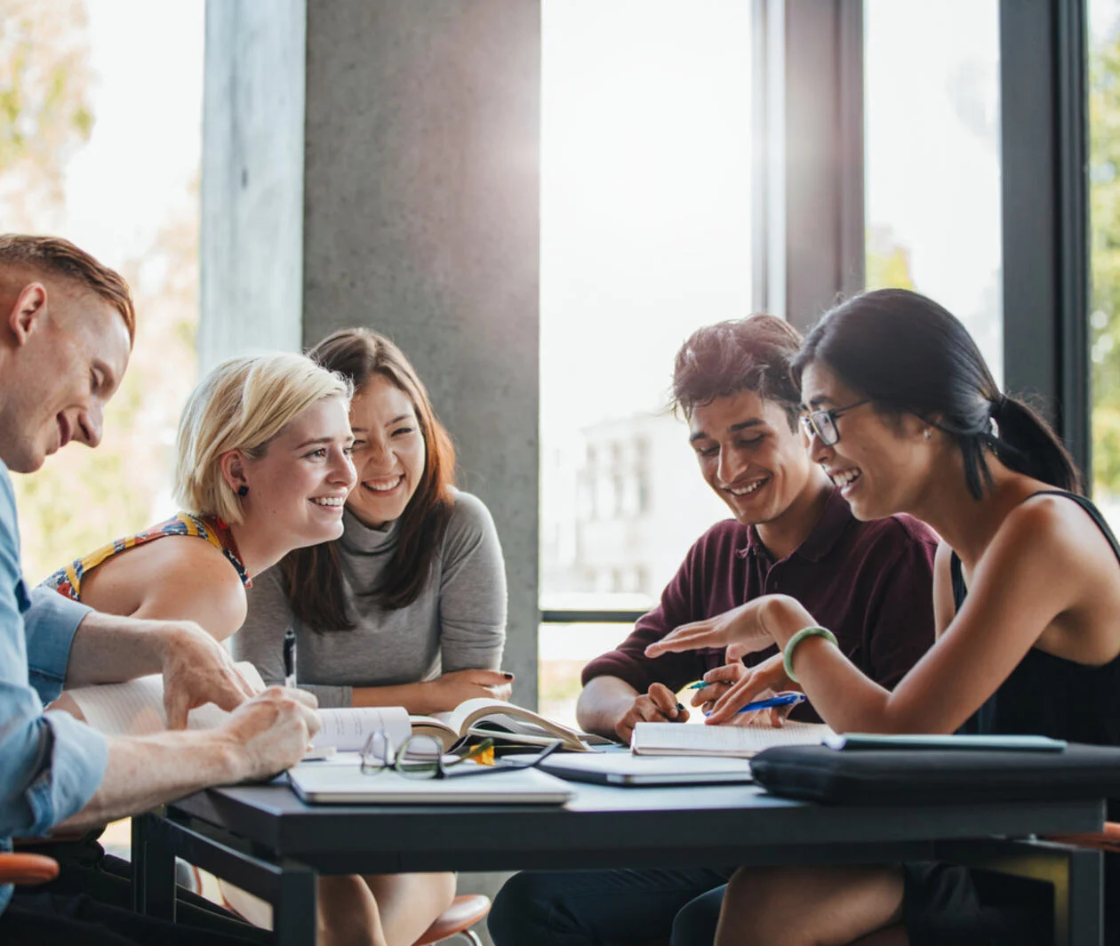 4 students happy around a table