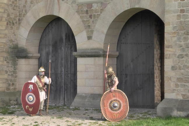 Photo of the reconstructed gate at Arbeia Roman Fort, South Shields with 2 students in costume as guards.