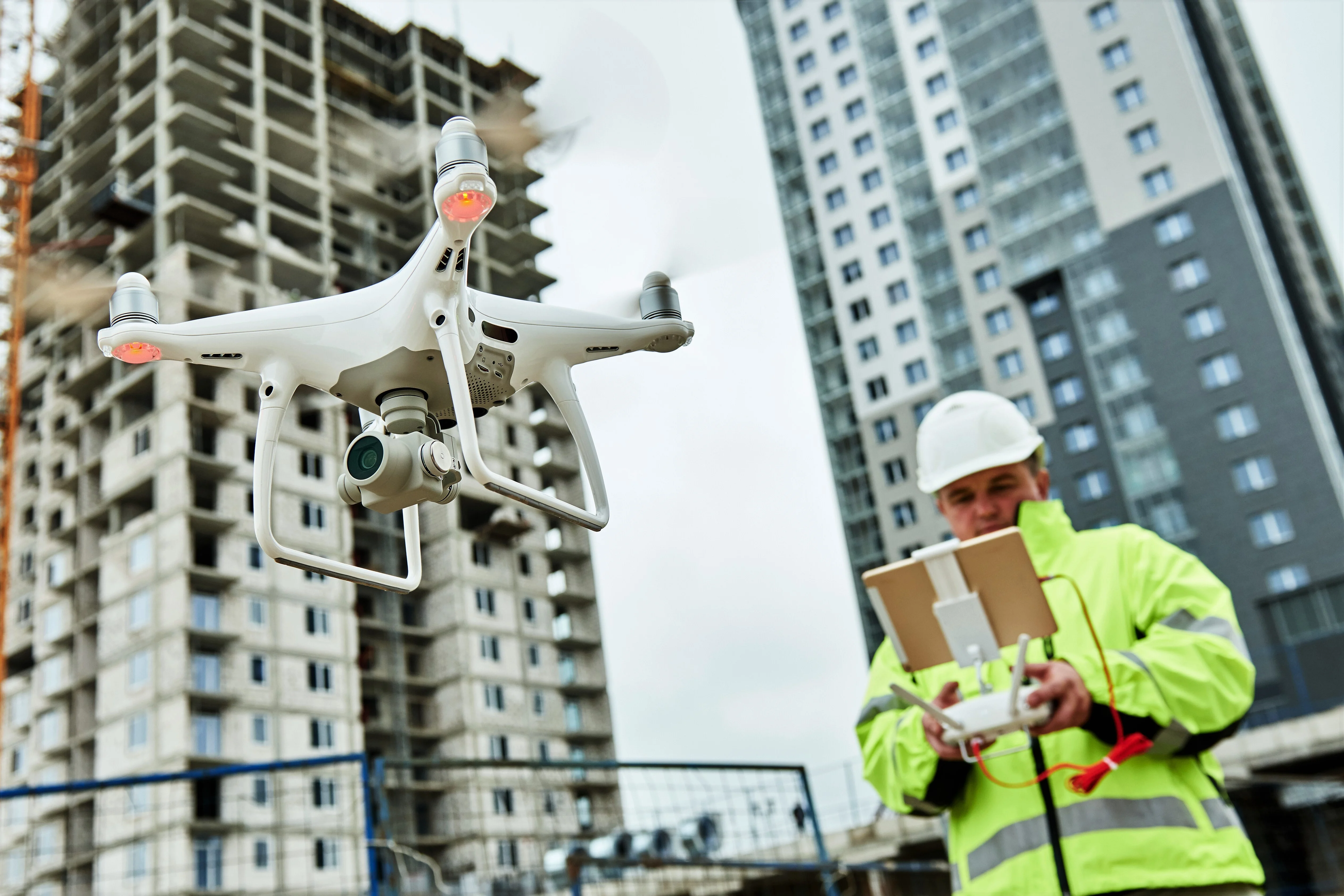 Man in reflective safety gear flying a drone