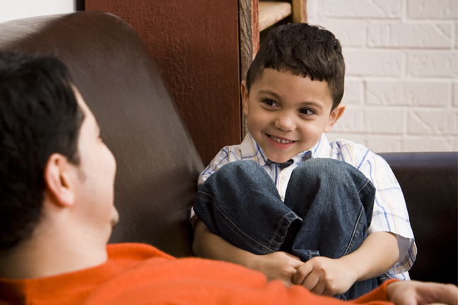 Boy smiling at man