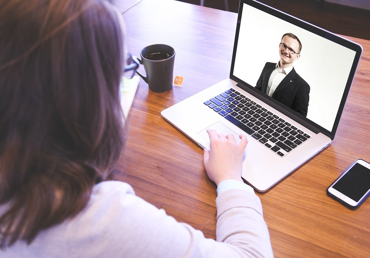 Illustration of a person working at a laptop and in conversation with someone online