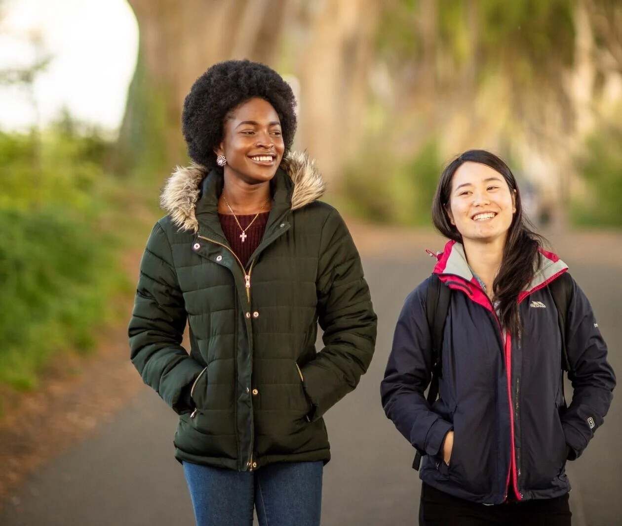 Two students walking through the woods