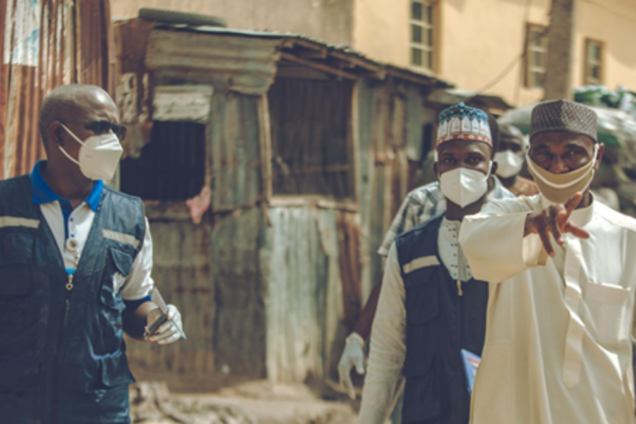 Three men in Nigeria with protective masks on