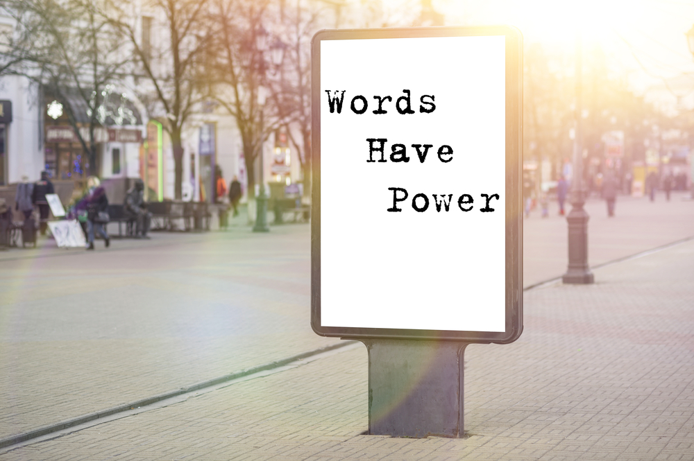 A sign board with text that says 'Words have power'