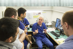 Doctor sitting down talking to students