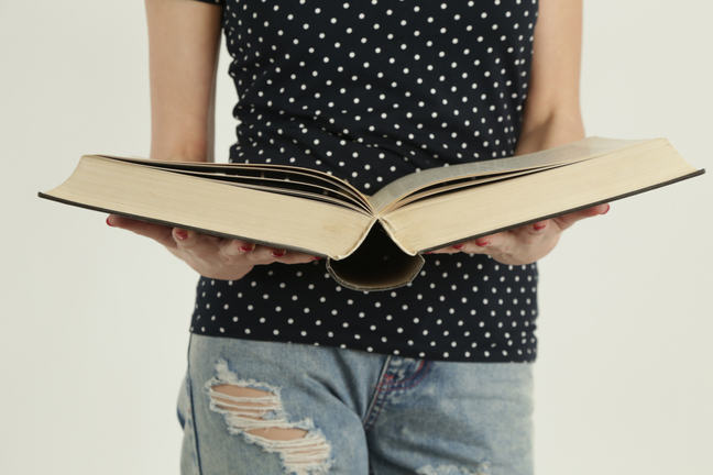 Woman looking in dictionary