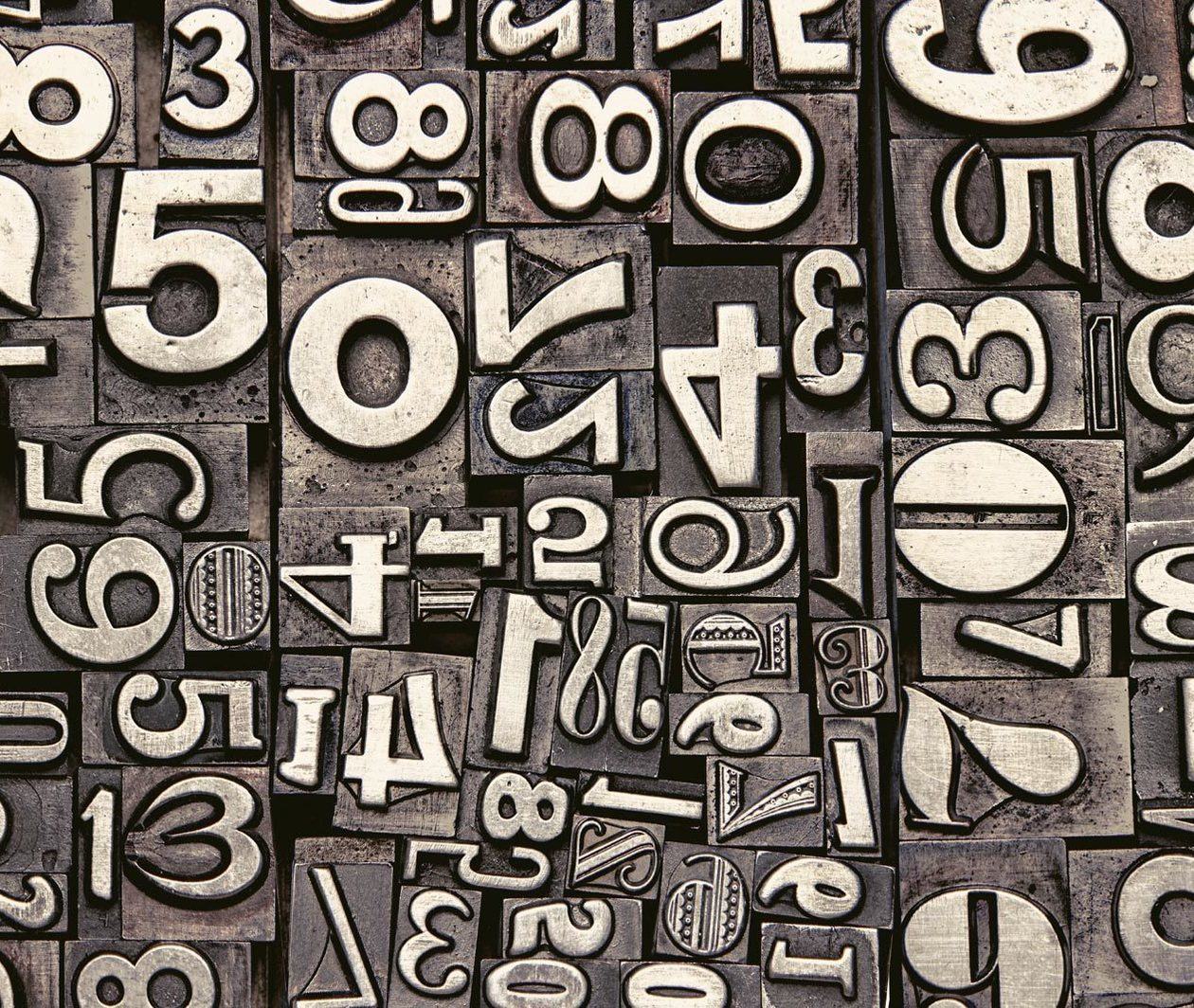 Maths Puzzles: a photograph of old metal numbers