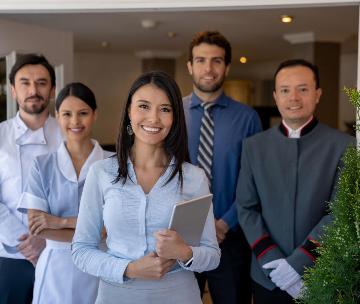 A group of hotel workers stood together in a doorway