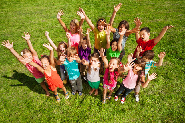 Group of children and adults waving