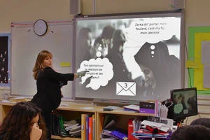 Lead educator Muriel teaching language in a classroom at the whiteboard