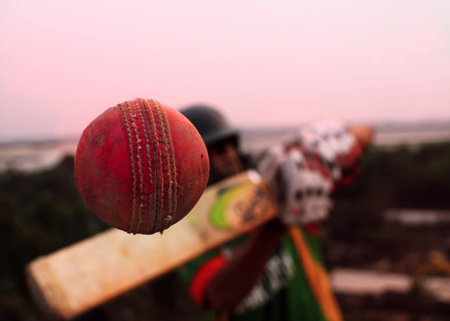 Conceptual cricket shot, close-up of a ball coming off the bat