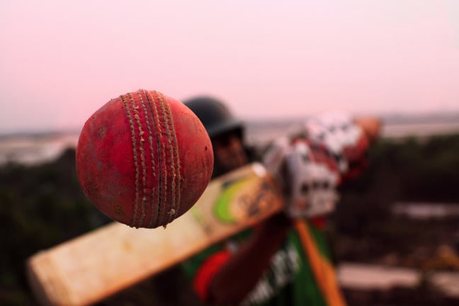 Conceptual cricket shot, close-up of a ball coming off the bat