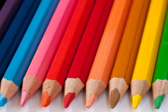A Row of Coloured Pencils Placed Together with Their Sharpened Ends Facing Forwards